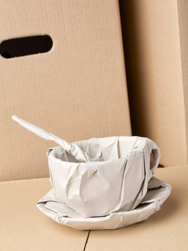 A fragile coffee cup wrapped in packaging paper from a Pro San Diego Mover