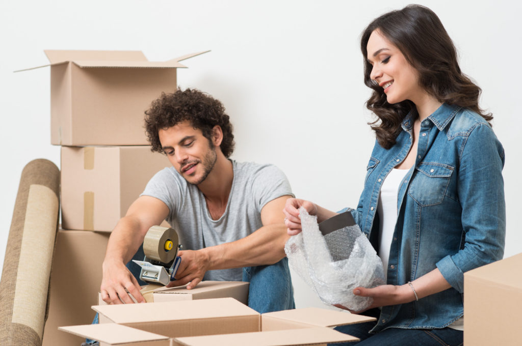 A happy couple moving boxes like a Pro San Diego Movers